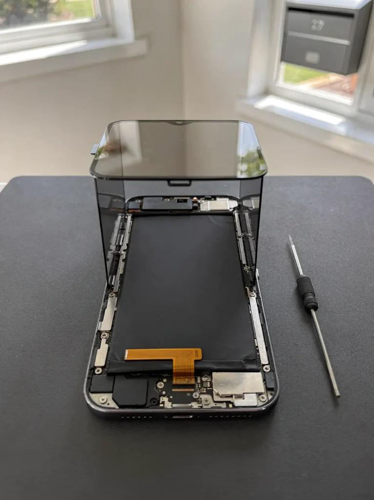 Open smartphone with new battery seated during repair in West Perth.